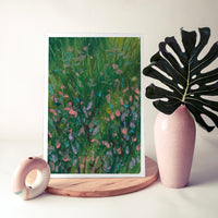 Flower Patch art print on a timber board beside a pink vase and a palm leaf (mock-up)